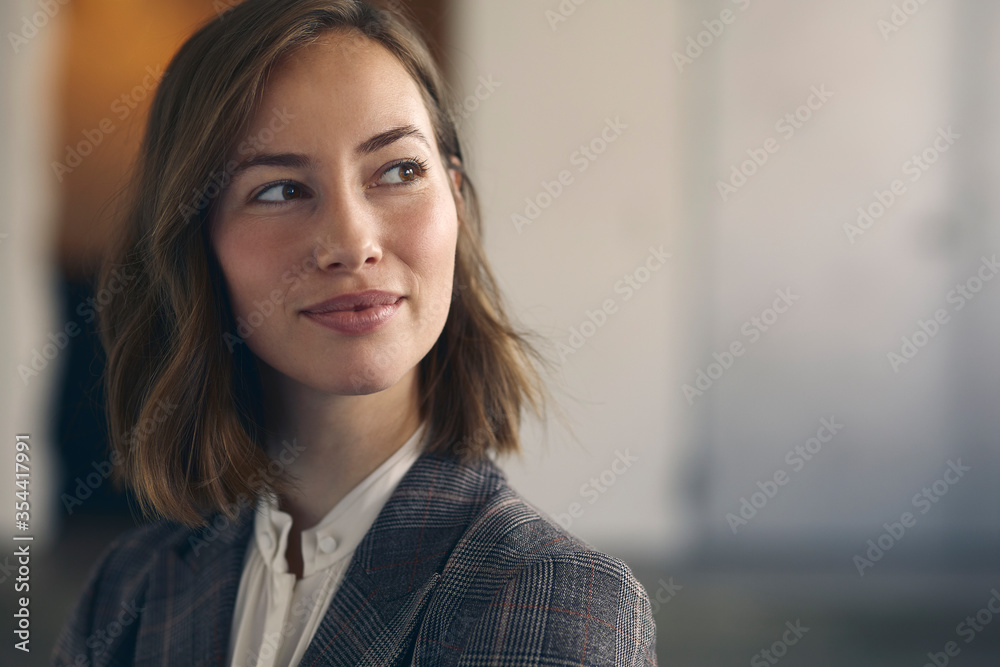 Close up portrait of beautiful business woman wearing a suit in office ...