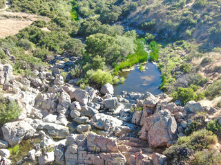 Poster - Aerial view of Los Penasquitos Canyon Preserve with the creek waterfall and people enjoying the water. Urban park with trails and river in San Diego, California. USA