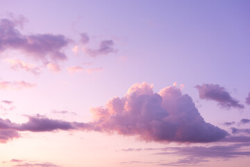 Soft purple clouds on sunset sky background. Pastel colored cloudscape. Pink clouds background