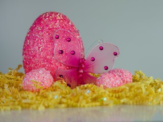 Wall Mural - Closeup shot of a decorative Easter egg and a butterfly