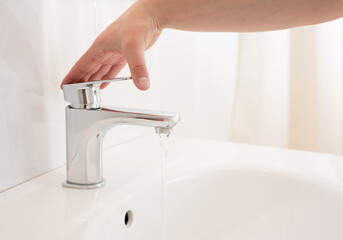 Modern bathroom. Running water from the faucet. Water tap.  