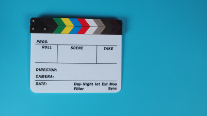 Clapperboard or movie slate on blue background.