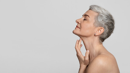 anti-age treatment. beautiful middle-aged woman touching soft skin on her neck