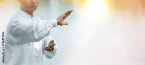 фотографія Young man practicing traditional Tai Chi Chuan, Tai Ji and Qi gong in the park for healthy, traditional chinese martial arts concept