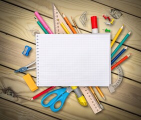 Poster - An assortment of colored school supplies on the desk