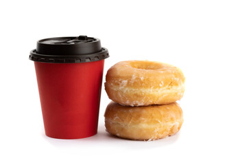 two honey glazed donuts stacked beside a red takeout coffee cup isolated on white