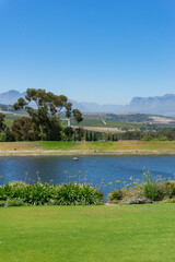 Wall Mural - Countryside landscape with pond, lake and green grass