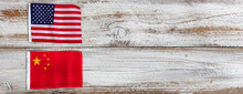 National Flags Representing China And The United States On White Rustic Wooden Background
