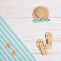 Sticker - Summer composition, towel, beach slippers, hat, sunglasses on white wood, summer background with copy space. Pastel colored. Vacation by sea.