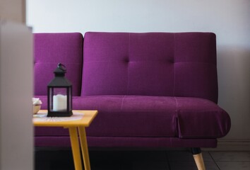 Wall Mural - Modern interior with a purple sofa and a wooden table