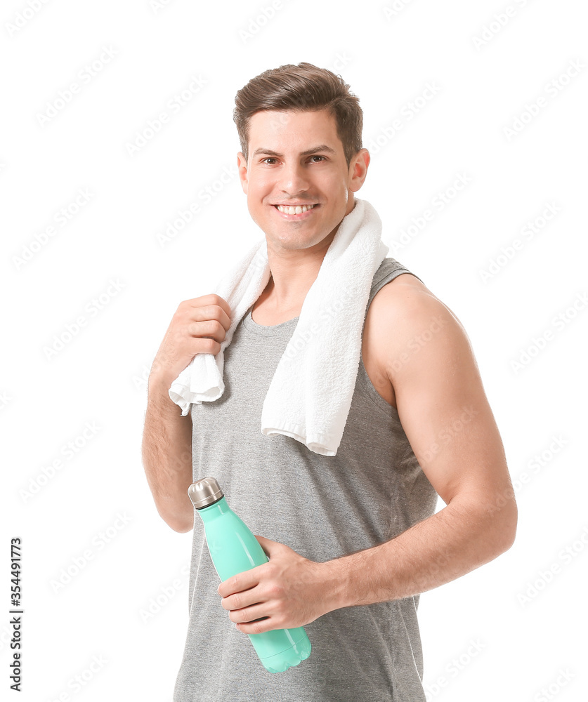 Sporty young man with water on white background