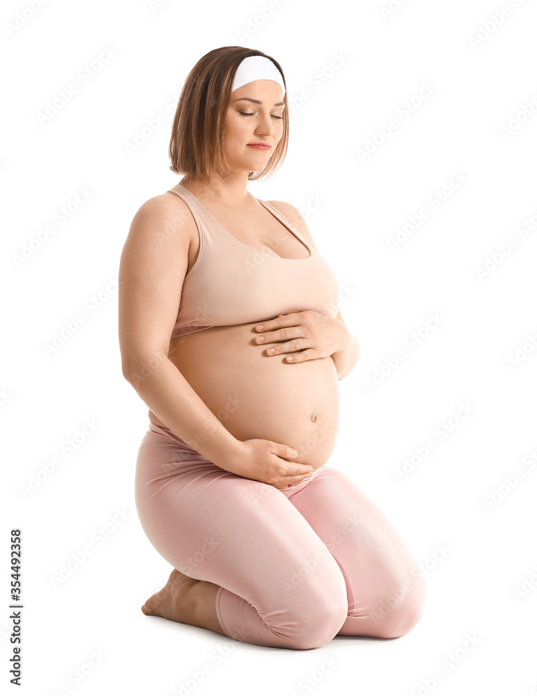 Young pregnant woman on white background