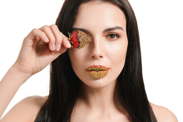 Wall Mural - Sexy young woman with strawberry on white background