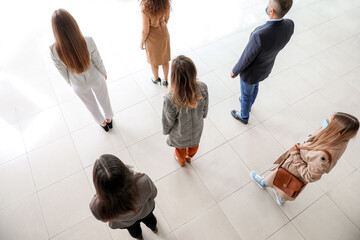 group of people standing with social distance indoors. concept of epidemic