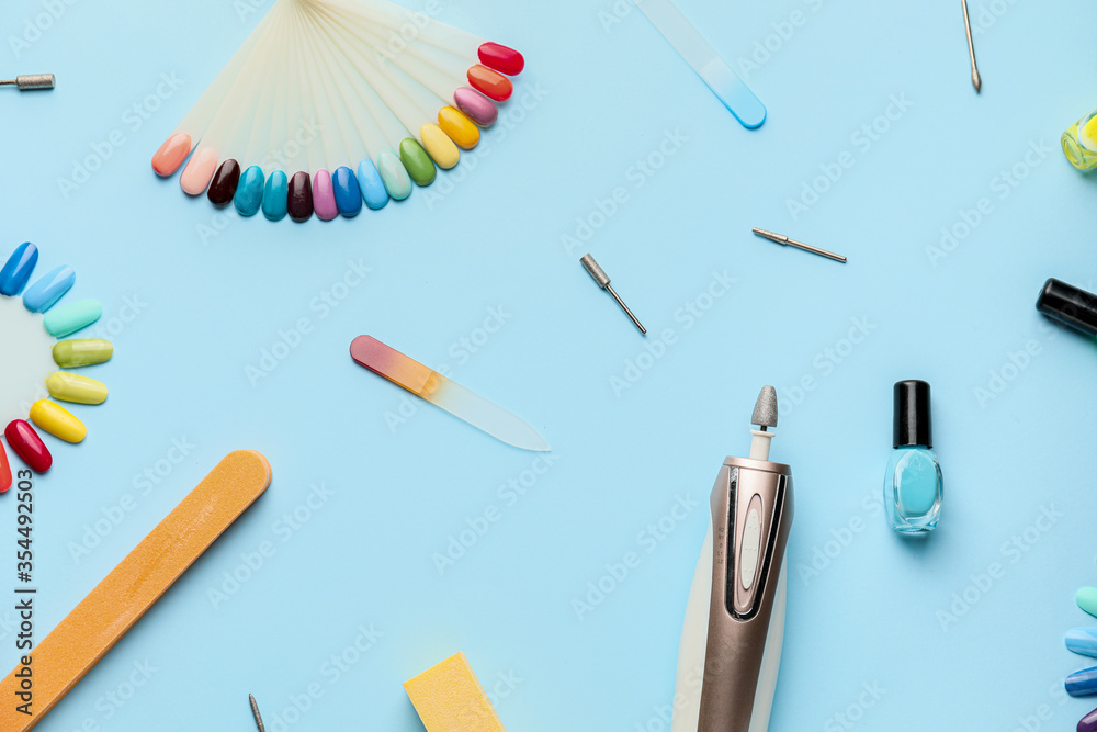 Supplies for manicure on color background