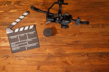 Movie production clapper board over wooden background. Video Equipment. Top view. Copy space.