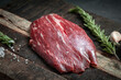 © Andrey - Raw flank beef steak and ingredients for cooking on a wooden Board, close up