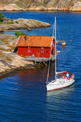 Wall Mural - Sailboat at an wooden boathouse at the coast