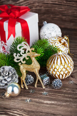 Wall Mural - Branch of Christmas tree with gift and balls. Stock photo.