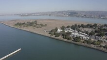 Row Of Sailboats Dry Docked By Berkeley Marina And Arid Brown Ground Of Cesar Chavez Park, California, Aerial