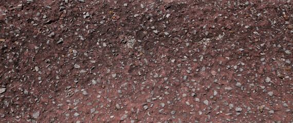 Close up a lot of small or tiny stones that are mixed with cement. The red surface of concrete wall, flooring texture and background for web design and architect.