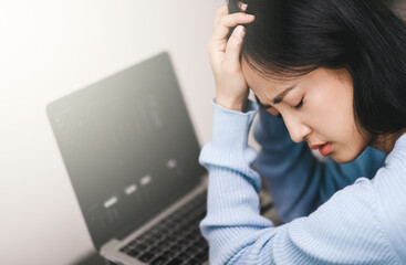 An Asian woman getting anxiety and depression after checking news about global pandemic.