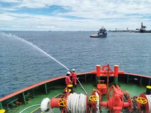 Marine Crew Conducting Fire Drill And Tested Fire Hydrant Pump On Board A Marine Offshore Vessel. 