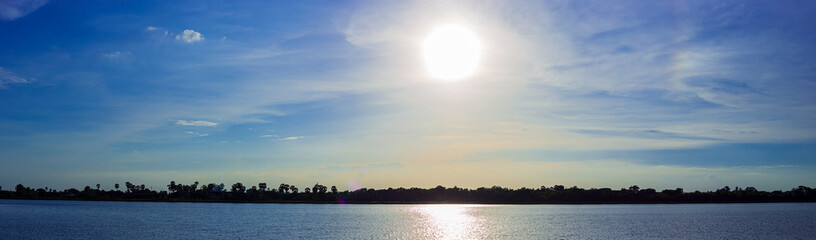 Wall Mural - Panorama blue sky with sun and lake at the sunset