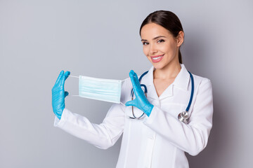 Poster - Photo of cheerful virologist doc lady professional advising patients use facial cotton mask good quality showing design wear medical uniform lab coat stethoscope isolated grey background