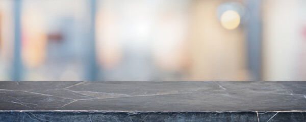 Empty black marble stone table top and blur glass window interior restaurant banner mock up abstract background - can used for display or montage your products.