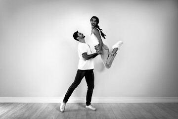 Wall Mural - Beautiful young couple dancing in modern studio