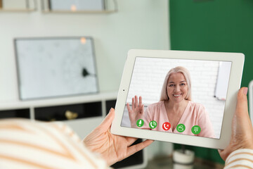 Canvas Print - Woman having video chat with her grandmother at home, focus on screen