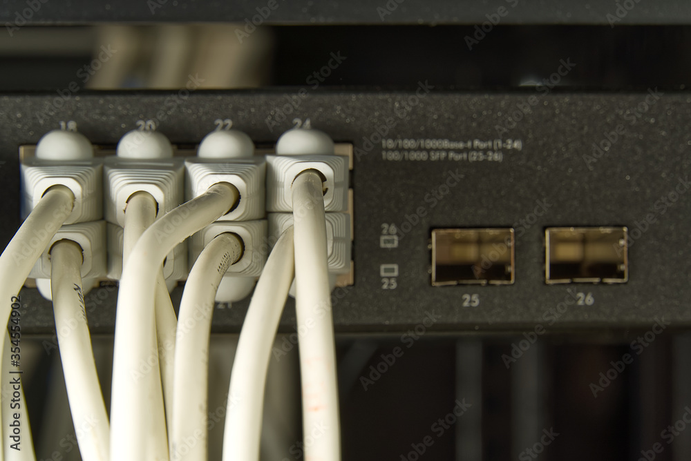 Network switch and ethernet cable in rack cabinet. Network connection ...