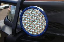 Blue Circular Led Driving Light Mounted On A Vehicle. Close Up