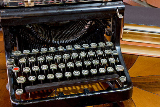 Old black typewriter  on the lacquered table