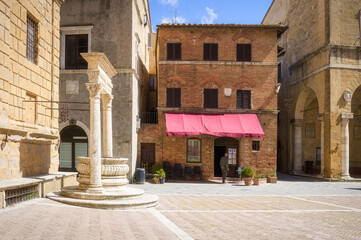 Wall Mural - Sunny streets with colorful flowers with contrasting shades. Walk the Tuscan town