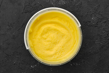 Wall Mural - Top view of homemade cream cheese in plastic bowl