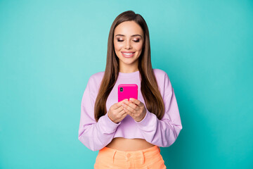 Poster - Photo of cool cheerful lady hold telephone hands write message e-mail wait friends meeting wear cropped pullover naked abdomen orange skirt isolated teal color background