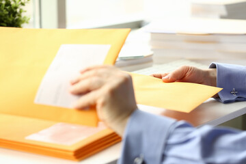 Focused photo on male hand that taking envelope