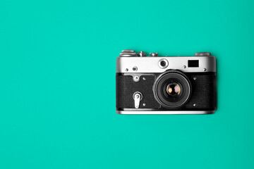 Retro camera isolated on bright blue background.