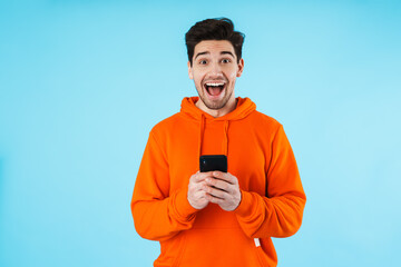 Wall Mural - Portrait of a cheerful young man wearing hoodie