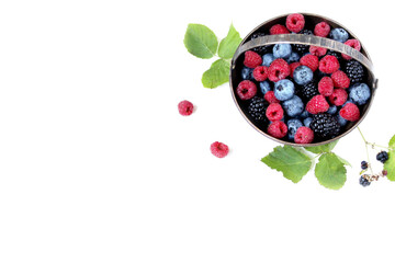 Poster - background with berries. Berries raspberries, blueberries and blackberries in a silver basket. Place for text. Copy space.