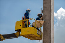 A Construction Worker Working At High In A Boom Lift