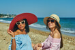 © fisher05 - Two young women on the seashore, girls in light dresses and straw hats
