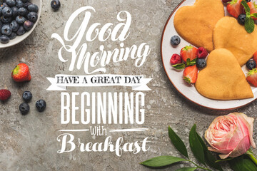 Wall Mural - top view of heart shaped pancakes with berries on grey concrete surface near rose, good morning, have great beginning with breakfast illustration