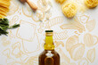 Top view of bottle of olive oil, rolling pin, pasta, garlic and rosemary on white background, food illustration