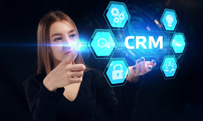 Business, Technology, Internet and network concept. Young businessman working on a virtual screen of the future and sees the inscription: CRM