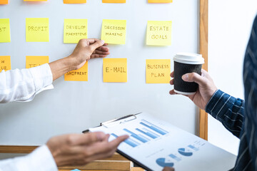 Poster - Two creative Business people meeting and planning use notes sticky note on white board to share idea, Analysis data charts and graph with teamwork strategy brainstorming