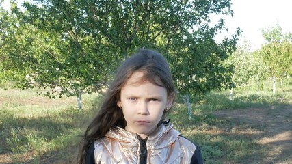 portrait of a little girl standing in the garden