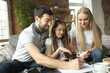 © master1305 - Mother, father and daughter at home having fun, comfort and cozy concept. Looks happy, cheerful and joyful. Beautiful caucasian family. Spending time together, drinking tea, playing games.